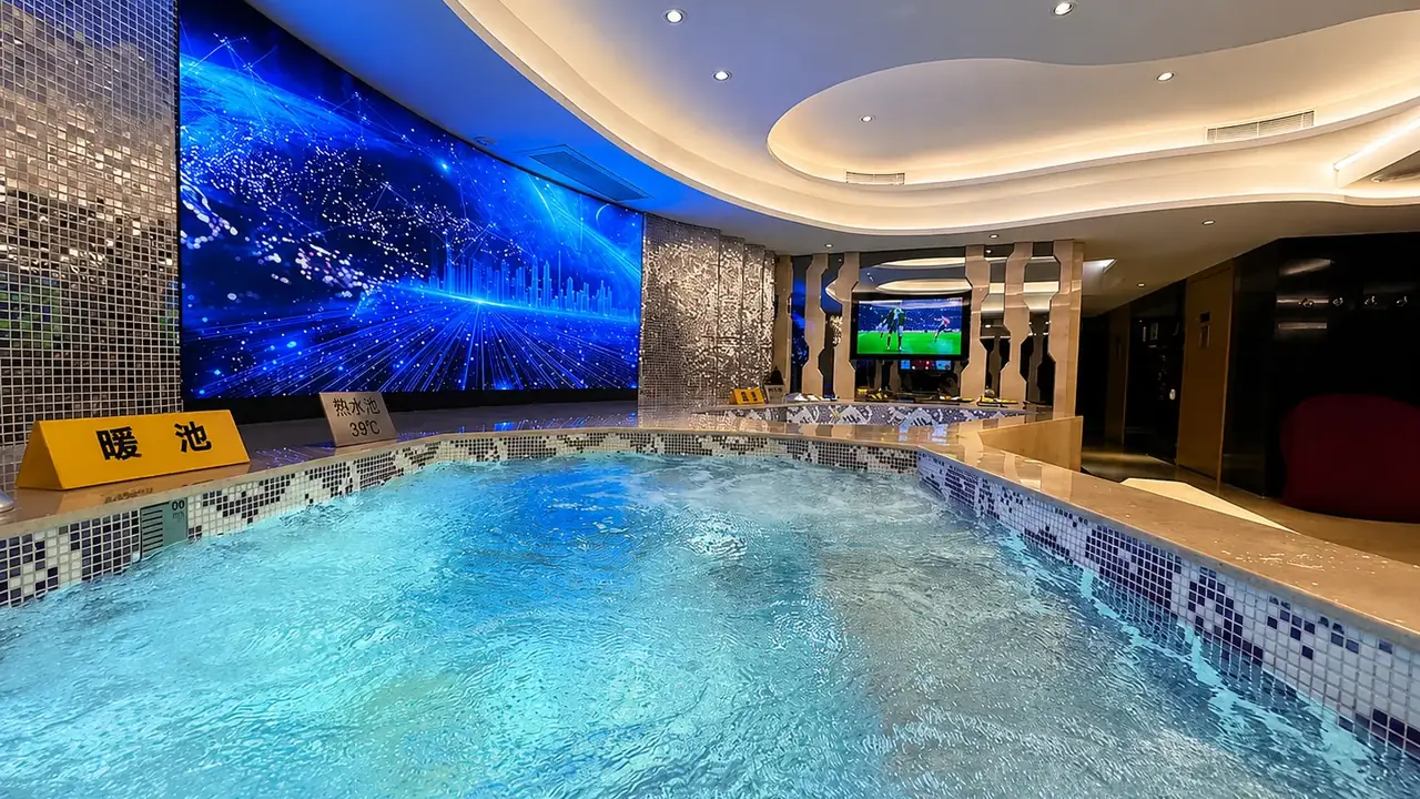 The warm indoor pool at East Castle Spa — a soaking pool beneath a starry screen wall and curved ceiling