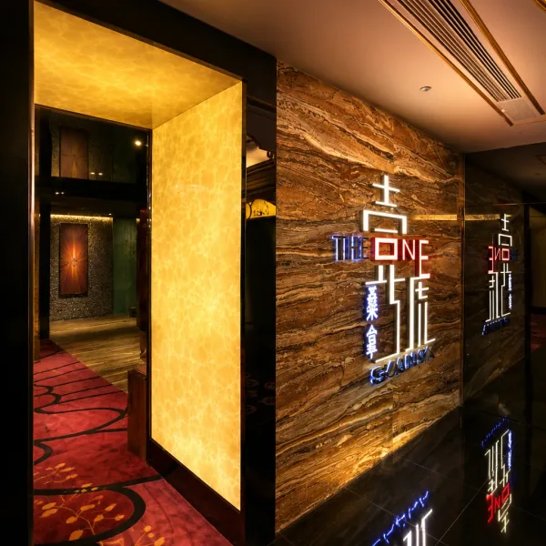 Black and gold lift lobby with illuminated wall graphics