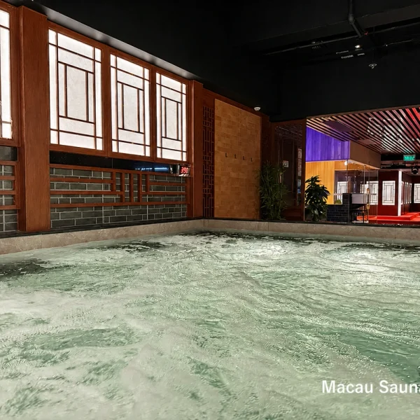 Low-angle view across the Yu Sauna bubbling hot pool toward the sauna area